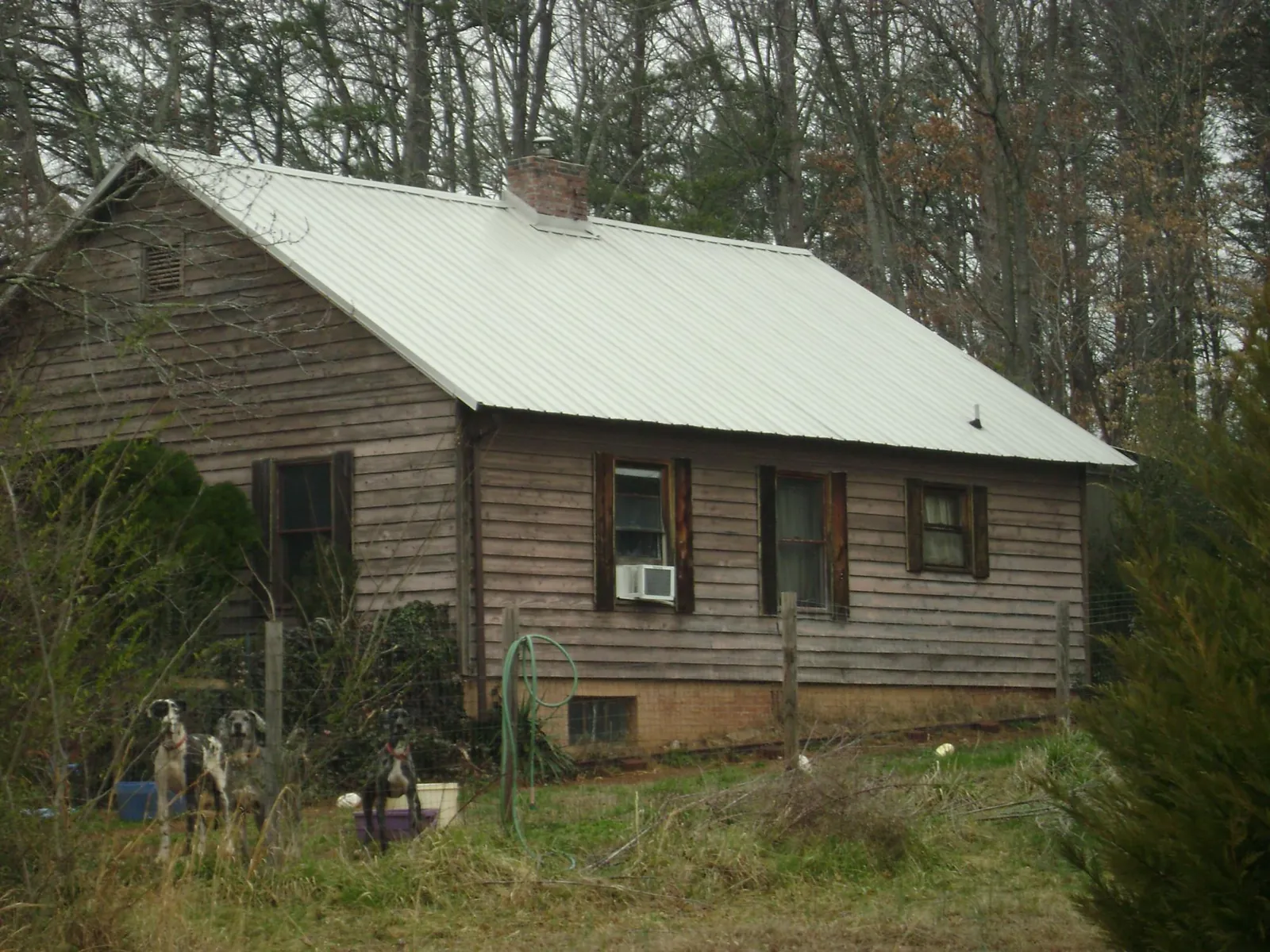 White metal roof on an old wood sided farmhouse, from a Metal Roof Installation job in Welton